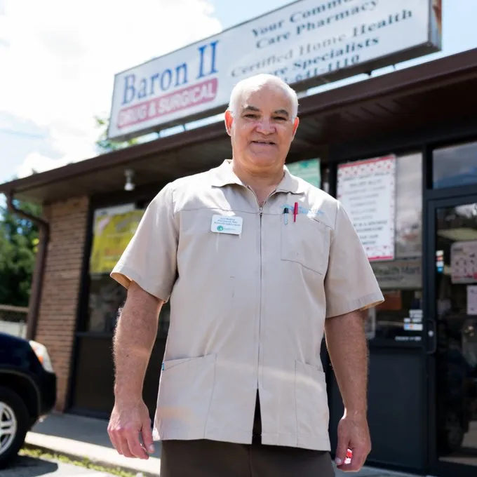 pharmacist greeting a patient inside Baron II Drug and Surgical